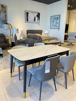 Dining table with marble-like top and gold legs