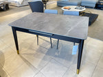 Dining table with marble-like top and gold legs
