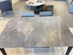Dining table with marble-like top and gold legs