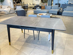 Dining table with marble-like top and gold legs