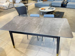 Dining table with marble-like top and gold legs