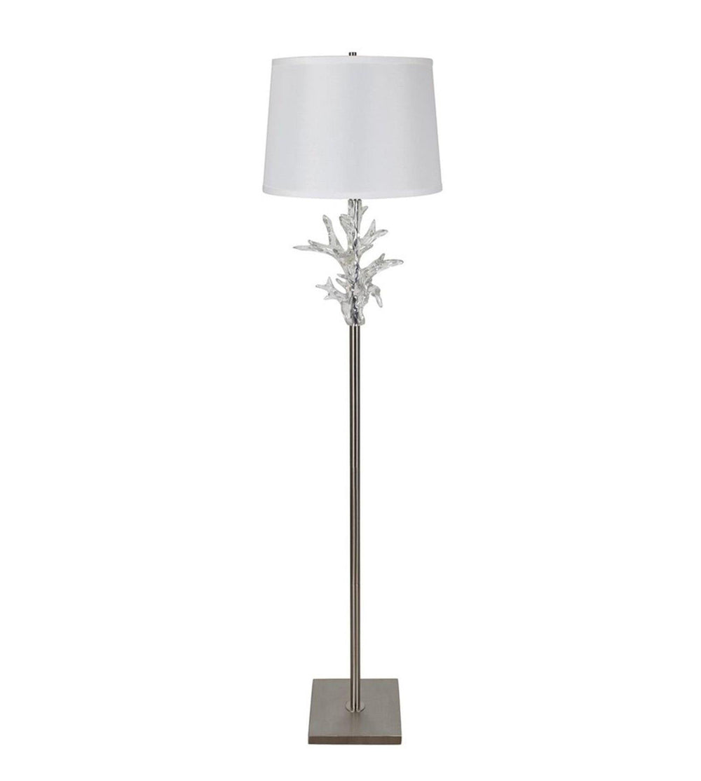 Floor lamp with decorative base and white shade on a white background