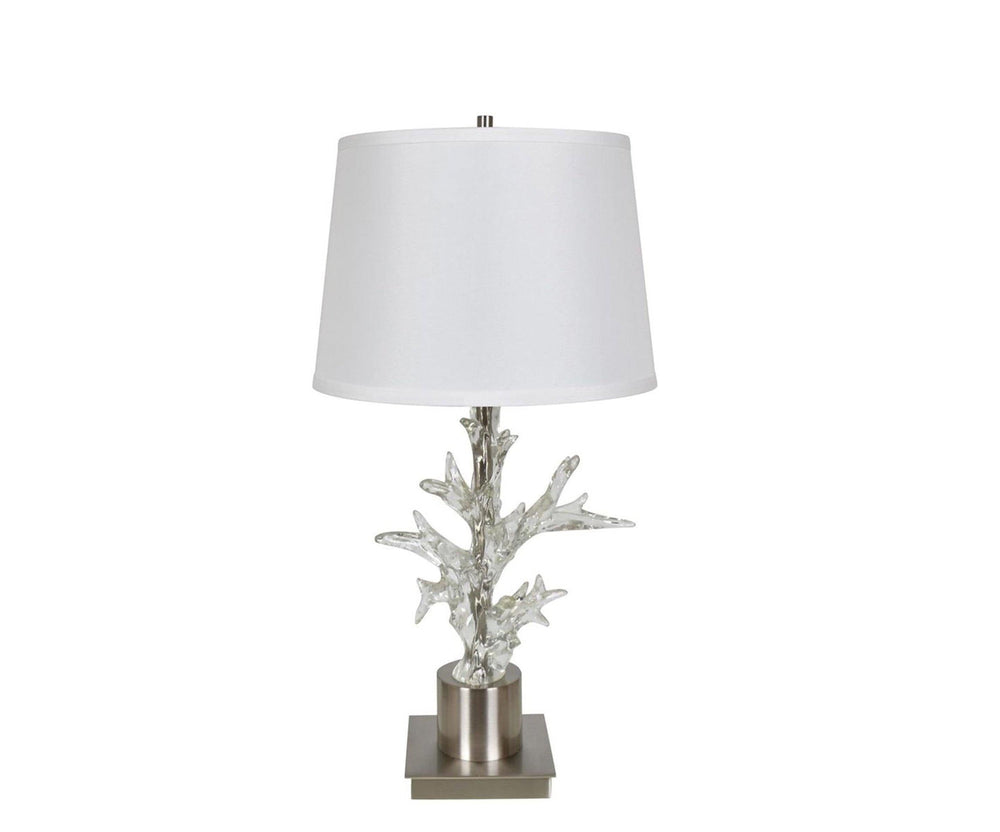 A floor lamp with a chrome base designed to resemble coral and a white lampshade.