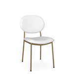 A white dining chair with a full backrest and gold-colored metal legs.
