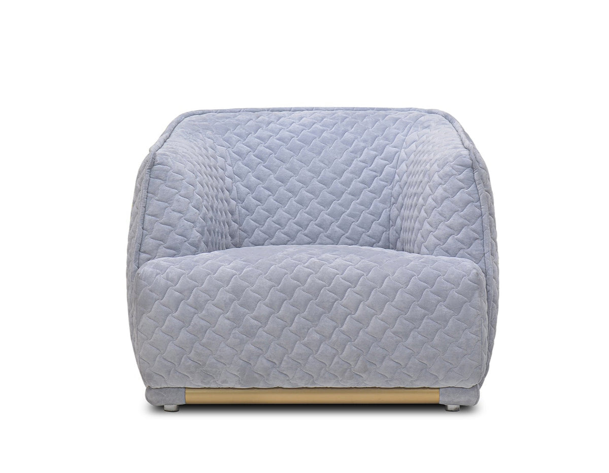 Light blue quilted armchair on a white background