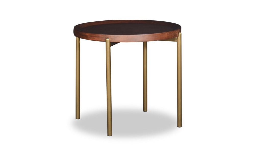 Small round table with dark top and brass legs on a white background