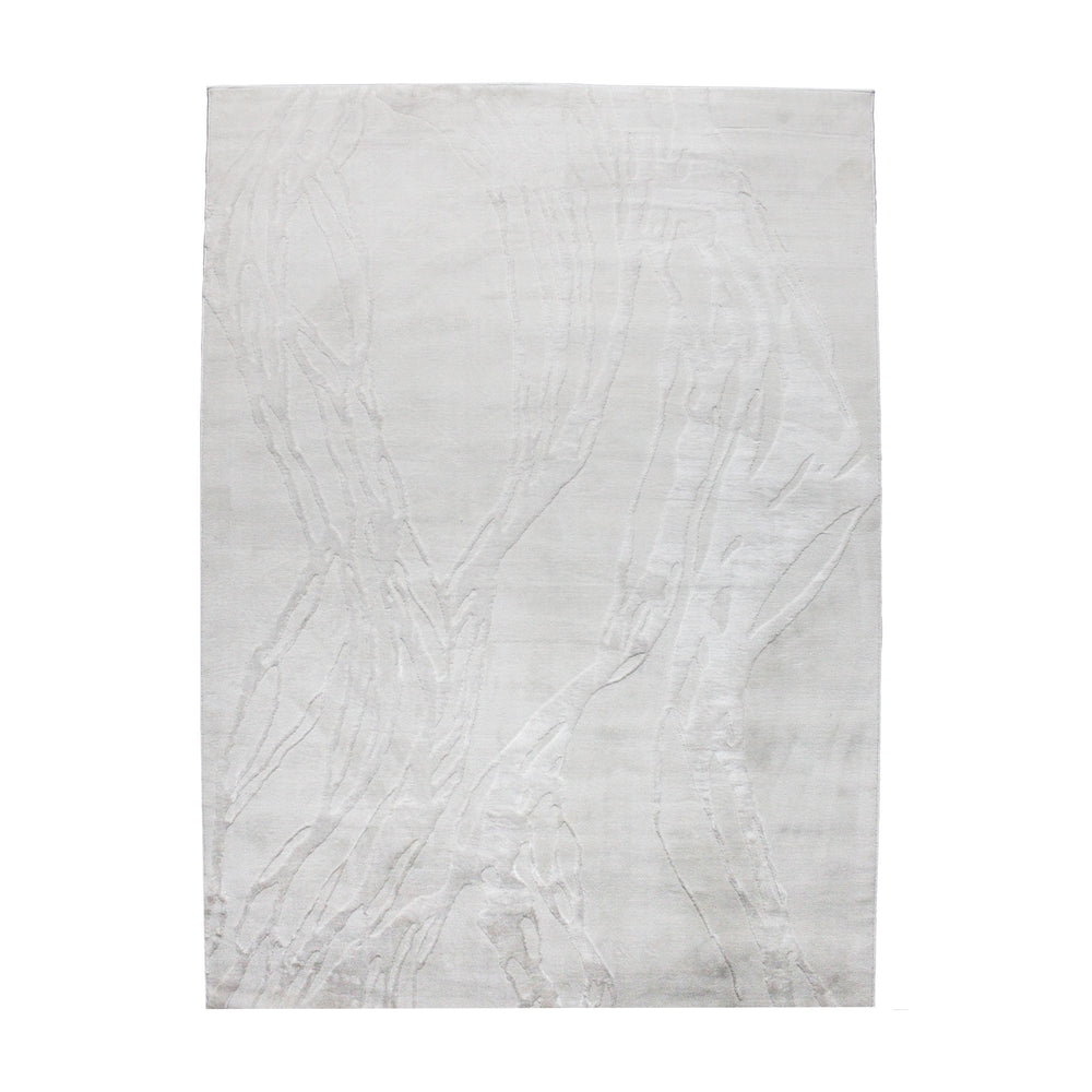 A power loomed Mila Area Rug in off white with a polypropylene and polyester construction and jute backing.