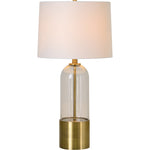 A mid-century modern table lamp with antique brass plated iron base and clear glass element, topped with an off-white shade.