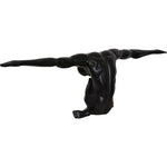 A black matte statue of a figure with arms outstretched, standing on a base, with a matte finish.