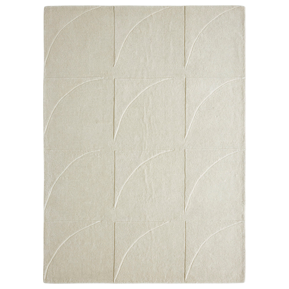 An ivory-colored wool area rug with a geometric patterned design, hand tufted with a cotton backing.
