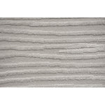 A power loomed area rug in light cream and grey colors with a polypropylene pile and jute backing.