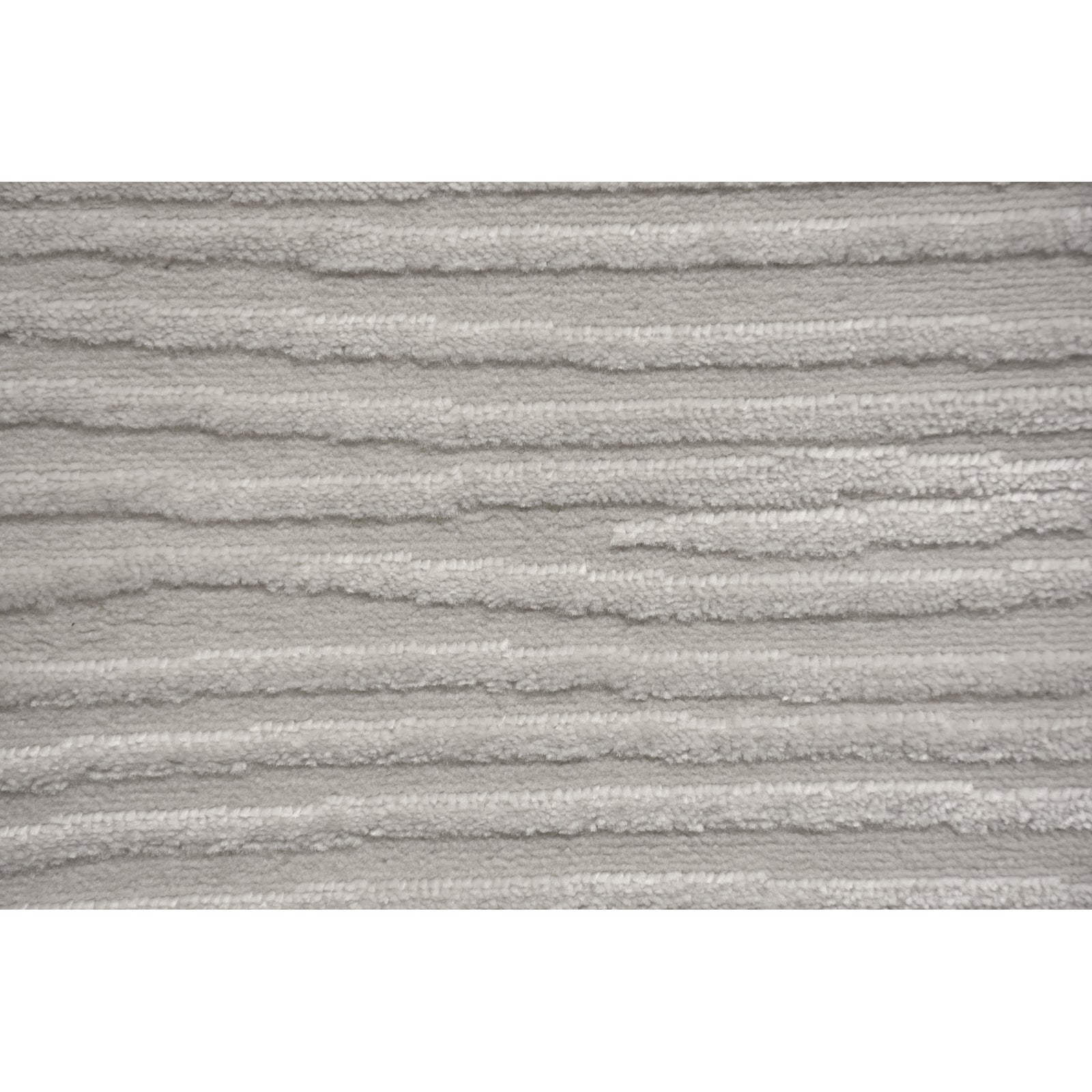 A power loomed area rug in light cream and grey colors with a polypropylene pile and jute backing.