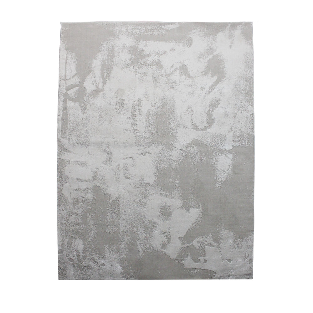 A rectangular jute rug with an abstract off-white and grey pattern.