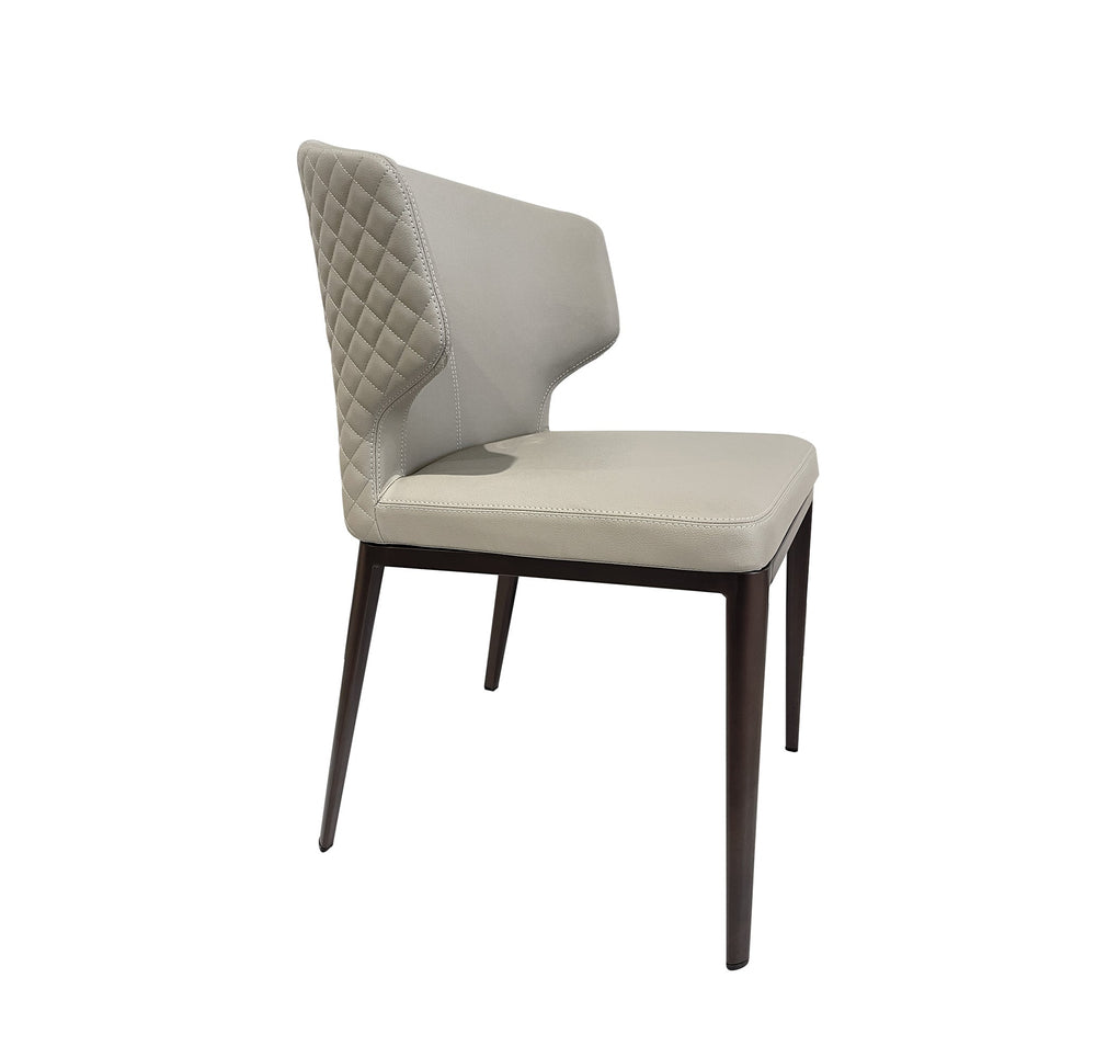 A beige upholstered dining chair with diamond quilted backrest, seated on a wooden frame.